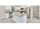 Modern kitchen featuring stainless steel appliances, granite countertops, and an island with bar seating at 174 Pine Crse, Ocala, FL 34472