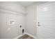 A modest laundry room including hookups, shelving, and a door for simple utility at 174 Pine Crse, Ocala, FL 34472