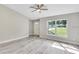 Bright living room with new gray flooring and large windows providing natural light at 174 Pine Crse, Ocala, FL 34472