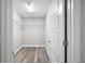 This walk-in closet features custom shelving and durable wood-look flooring at 174 Pine Crse, Ocala, FL 34472