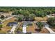 Aerial view of a green home with mature trees and a long driveway in a rural area at 176 Pine Crse, Ocala, FL 34472