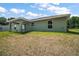 The backyard has a covered patio, lush green grass and is perfect for outdoor entertaining at 176 Pine Crse, Ocala, FL 34472