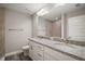 Bathroom with double sink vanity with granite countertop and large mirror at 176 Pine Crse, Ocala, FL 34472