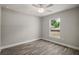 Bedroom with a fan, wood-look flooring and a window providing lots of natural light at 176 Pine Crse, Ocala, FL 34472