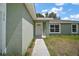 Inviting front entrance featuring a white door, textured walls and a concrete walkway at 176 Pine Crse, Ocala, FL 34472