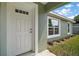 Close-up of a front door with glass accents and clean, manicured landscaping at 176 Pine Crse, Ocala, FL 34472