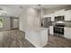 Modern kitchen features stainless steel appliances, granite counters, and center island at 176 Pine Crse, Ocala, FL 34472