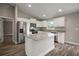 Modern kitchen featuring stainless steel appliances, granite countertops, and white cabinetry at 176 Pine Crse, Ocala, FL 34472
