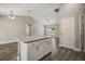 Open kitchen featuring granite island with cabinets and stylish wood-look flooring at 176 Pine Crse, Ocala, FL 34472