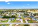 Aerial view showcasing a home in a tranquil neighborhood with mature trees and well-maintained lawns at 17890 Se 96Th Ct, Summerfield, FL 34491