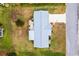 Aerial view of a home with a gray roof, a well-manicured lawn, and a driveway, in a neighborhood at 17890 Se 96Th Ct, Summerfield, FL 34491
