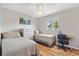 Comfortable bedroom with a ceiling fan, natural light, and a cozy atmosphere at 17890 Se 96Th Ct, Summerfield, FL 34491
