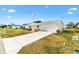 Attractive one-story home with a tidy lawn, long driveway, and an attached garage, perfect for comfortable living at 17890 Se 96Th Ct, Summerfield, FL 34491