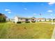 Inviting single-story home with a lush green lawn and a view of neighboring houses on a bright, sunny day at 17890 Se 96Th Ct, Summerfield, FL 34491