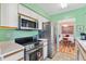 The kitchen features stainless steel appliances and a view into the dining room, perfect for modern living at 17890 Se 96Th Ct, Summerfield, FL 34491