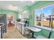 Sunlit kitchen with a cozy breakfast nook overlooking the outdoors and a view into the dining room at 17890 Se 96Th Ct, Summerfield, FL 34491