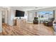Inviting living room showcasing hardwood floors, a large entertainment center, and comfortable seating arrangement at 17890 Se 96Th Ct, Summerfield, FL 34491