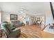 Spacious living room featuring hardwood floors, comfortable seating, and ample natural light perfect for relaxation at 17890 Se 96Th Ct, Summerfield, FL 34491