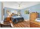 Bright main bedroom with hardwood floors and comfortable furnishings, offering a serene retreat at 17890 Se 96Th Ct, Summerfield, FL 34491
