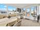 Bright sunroom featuring tile floor, dining table, and grill, perfect for outdoor enjoyment at 17890 Se 96Th Ct, Summerfield, FL 34491