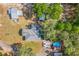 Aerial view of a beautiful property featuring a pool, detached garage, and well-maintained landscaping at 1839 Cr 543A, Sumterville, FL 33585