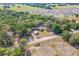 Overhead view of the property nestled among mature trees in a tranquil neighborhood setting at 1839 Cr 543A, Sumterville, FL 33585