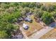Property aerial view with a long driveway leading to the house surrounded by trees and outbuildings at 1839 Cr 543A, Sumterville, FL 33585