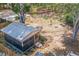 Aerial view of the backyard showcasing a detached structure, fire pit, and mature trees at 1839 Cr 543A, Sumterville, FL 33585