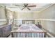 Comfortable bedroom with a wooden bed frame, ceiling fan, and charming decor at 1839 Cr 543A, Sumterville, FL 33585