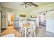 Open concept dining and kitchen area with stainless steel appliances and light-colored wood floors at 1839 Cr 543A, Sumterville, FL 33585