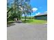Wide driveway leading to the home with lush green lawns on the sides at 1839 Cr 543A, Sumterville, FL 33585