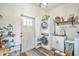 Functional laundry room with a stacked washer and dryer and a sink, plus ample storage shelves at 1839 Cr 543A, Sumterville, FL 33585