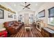 Inviting living room featuring wood floors, comfortable seating, and a cozy fireplace for relaxing evenings at home at 1839 Cr 543A, Sumterville, FL 33585
