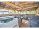 Relaxing outdoor space with a private hot tub, comfortable seating, and wooden beam construction at 1839 Cr 543A, Sumterville, FL 33585