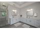 Bright bathroom showcasing double sinks, stylish mirrors, and ample counter space at 2050 Nw 79Th Loop, Ocala, FL 34475