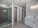 Modern bathroom featuring a glass-enclosed shower, double sink vanity, and bright lighting at 2050 Nw 79Th Loop, Ocala, FL 34475
