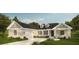 Inviting single-story home with a manicured front yard, dormer windows, a neutral color palette, and an attached garage at 2050 Nw 79Th Loop, Ocala, FL 34475