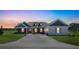 Beautiful single-story home featuring a stone facade, dormer windows, and a well-manicured front lawn at 2050 Nw 79Th Loop, Ocala, FL 34475