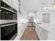 Bright, modern kitchen with an island, stainless steel appliances, and white cabinets at 2050 Nw 79Th Loop, Ocala, FL 34475