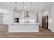 Well-lit kitchen featuring a large island, stainless steel appliances, and a sleek design at 2050 Nw 79Th Loop, Ocala, FL 34475