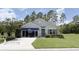 Charming single-story home with well-manicured lawn, tasteful landscaping and inviting storefront style front entrance at 24 Hickory Crse, Ocala, FL 34472