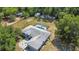 Aerial view of the house featuring a screened pool, lush green surroundings, and additional buildings at 2698 Sw 186Th Ct, Dunnellon, FL 34432