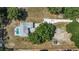 Aerial view of a property with a backyard pool, mature trees, and a large yard at 2698 Sw 186Th Ct, Dunnellon, FL 34432
