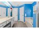 Bathroom with double sink vanity, soaking tub, blue walls, and tiled floors at 2698 Sw 186Th Ct, Dunnellon, FL 34432