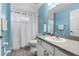 Bright bathroom with blue walls, tiled floors, and a shower/tub combo with granite counters at 2698 Sw 186Th Ct, Dunnellon, FL 34432