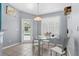 Breakfast nook with view to the pool, table, and hanging light fixture at 2698 Sw 186Th Ct, Dunnellon, FL 34432