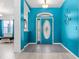 Inviting foyer featuring blue walls, tile floors, and an ornate front door at 2698 Sw 186Th Ct, Dunnellon, FL 34432