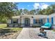 Charming single-story home featuring a colorful exterior and a well-manicured front yard at 2698 Sw 186Th Ct, Dunnellon, FL 34432