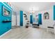 A living area with bright blue accent walls, and light wood look flooring at 2698 Sw 186Th Ct, Dunnellon, FL 34432