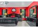 Bright main bedroom featuring a large bed and stylish black furniture set with red walls at 2698 Sw 186Th Ct, Dunnellon, FL 34432